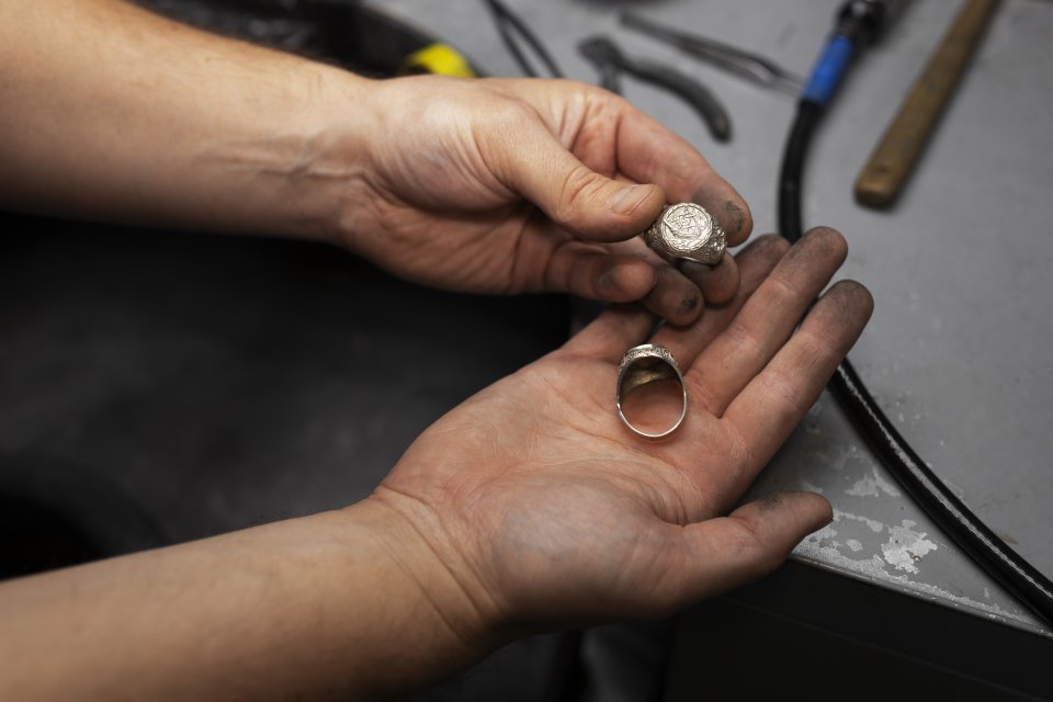 Craftsman's hands holding valuable rings for appraisal